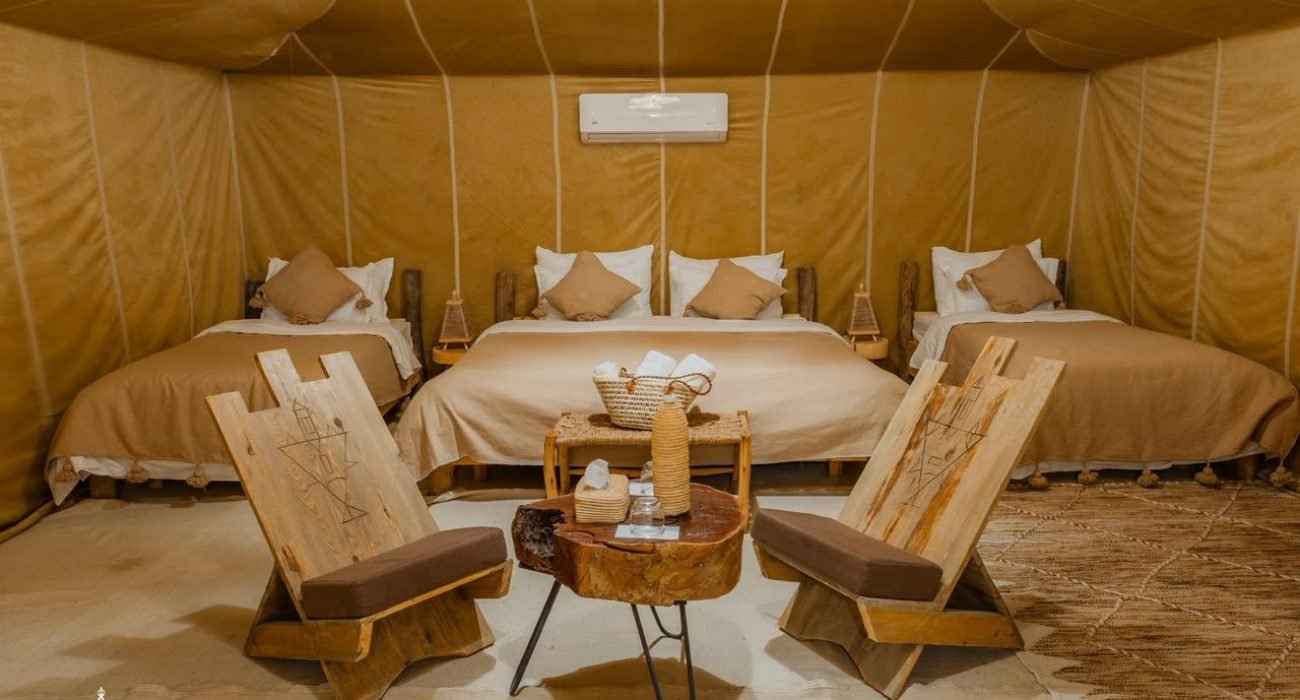 Suite tent with three beds at Dihya Desert Camp, Merzouga